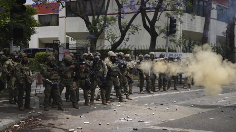 Agentes federales con equipo antimotines se enfrentan a manifestantes durante la redada de ICE en Camarillo, California.